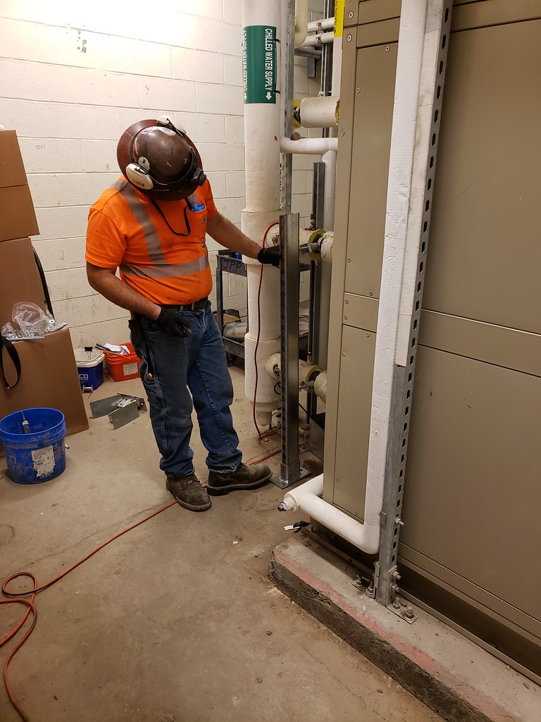 Installing various HVAC equipment for the air handling unit that will supply air to the future LIRR passenger terminal.